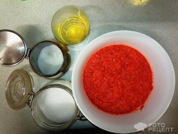 Пюре из красного перца в миске, растительное масло, сахар и соль на столе